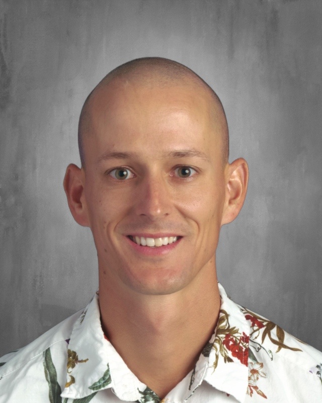 Photo of Lance Peterson with a grey background and a white shirt.